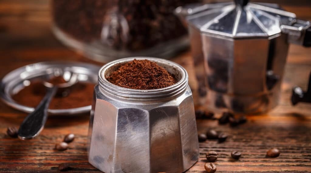 A Moka Pot filled with coffee grinds.