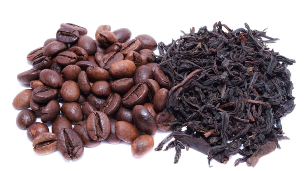 coffee beans and tea leaves side by side.