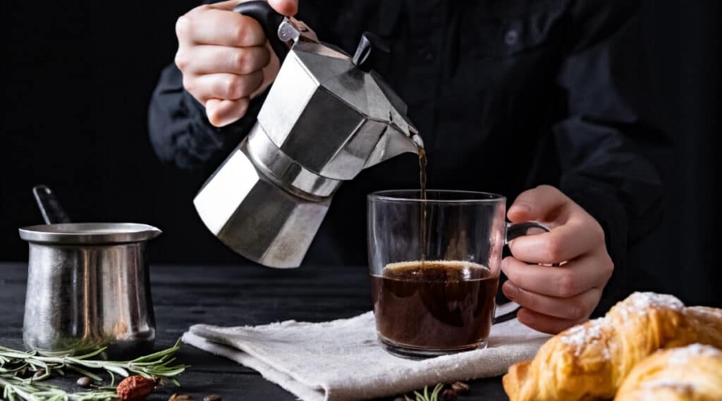 Percolator coffee poured into coffee cup. 